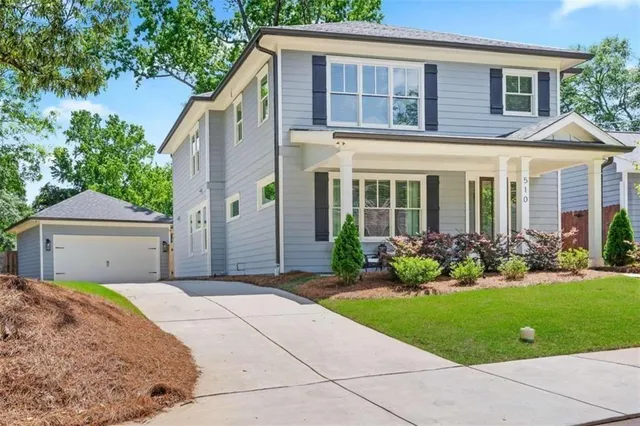 a front view of a house with a garden and plants