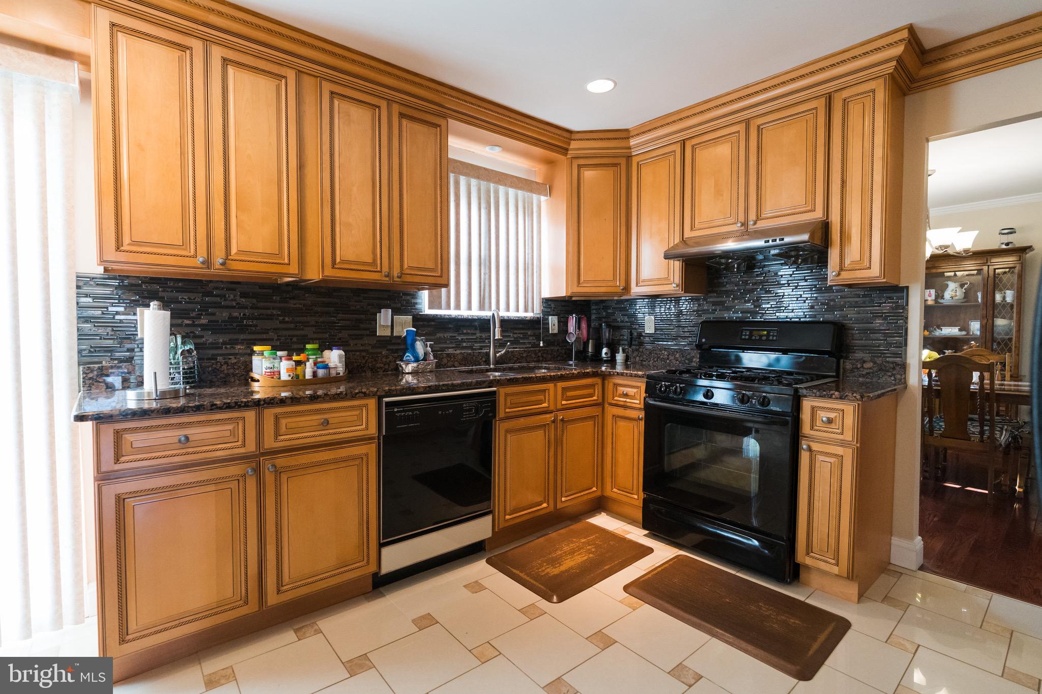 2 Danbridge Drive Horsham, PA 19044 - Photo 21 of 71 a kitchen with stainless steel appliances granite countertop a stove a sink and a microwave