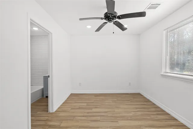a view of a room with wooden floor closet and windows
