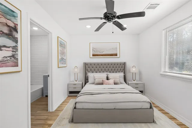 a bedroom with a large bed and a chandelier