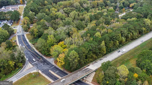 an aerial view of a forest with houses