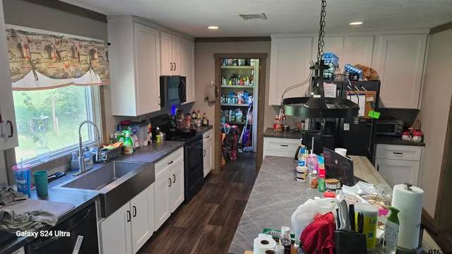 a kitchen that has a lot of stuff and refrigerator