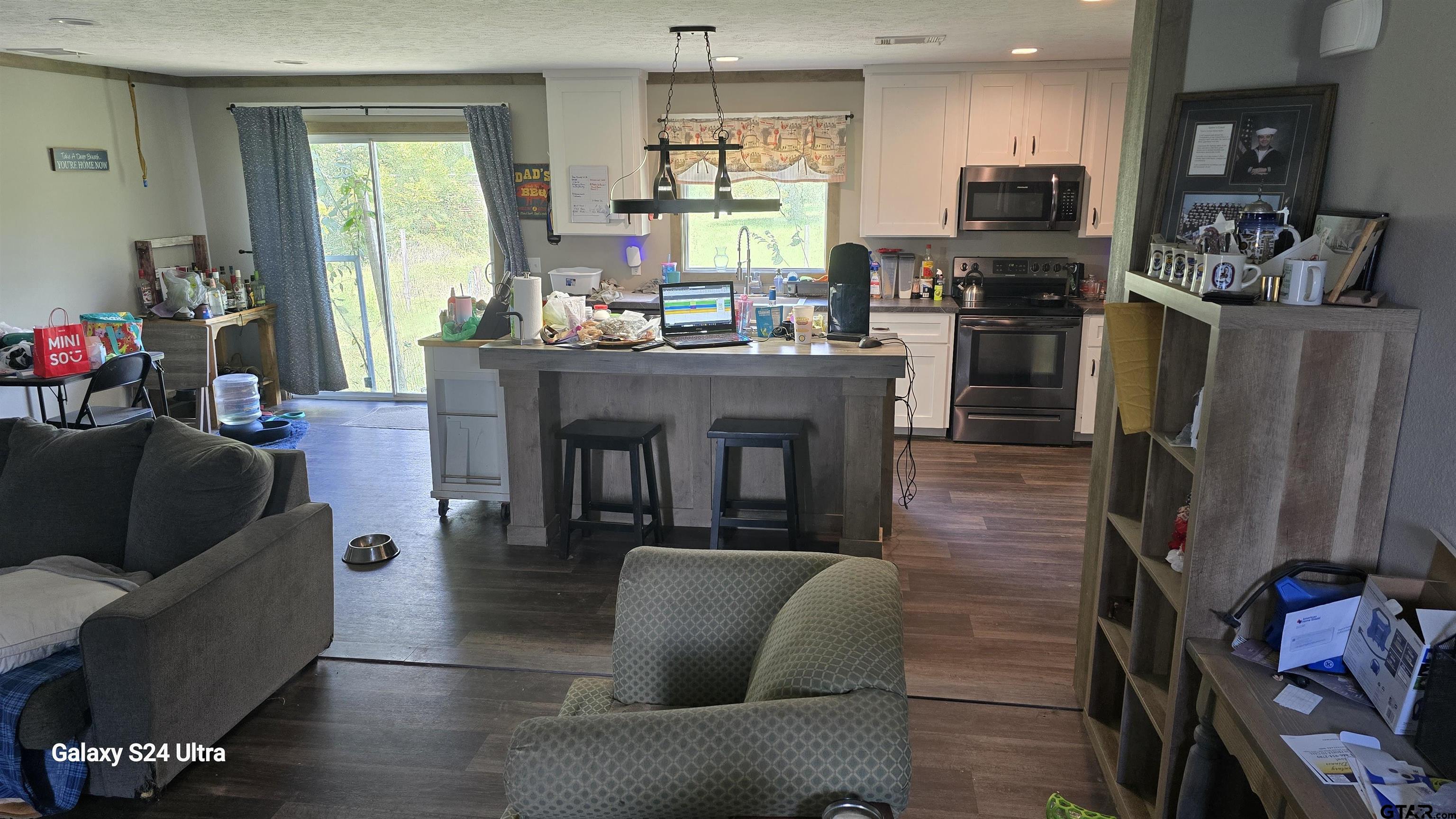 873 East Texas Road Lufkin, TX 75901 - Photo 5 of 12 a living room with stainless steel appliances furniture a fireplace a flat screen tv and a window