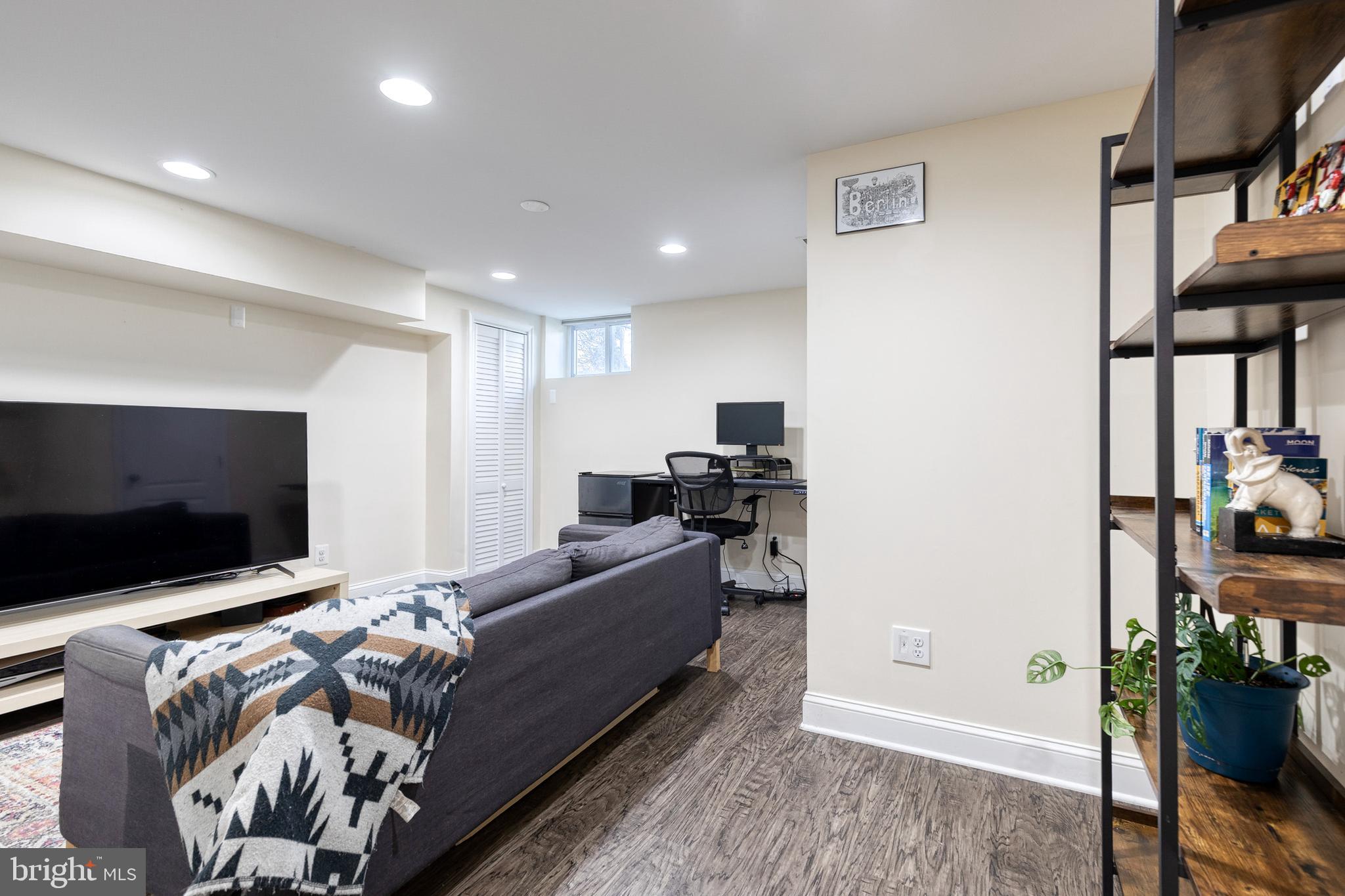 1205 Roland Heights Avenue Baltimore, MD 21211 - Photo 22 of 36 a living room with furniture and a flat screen tv
