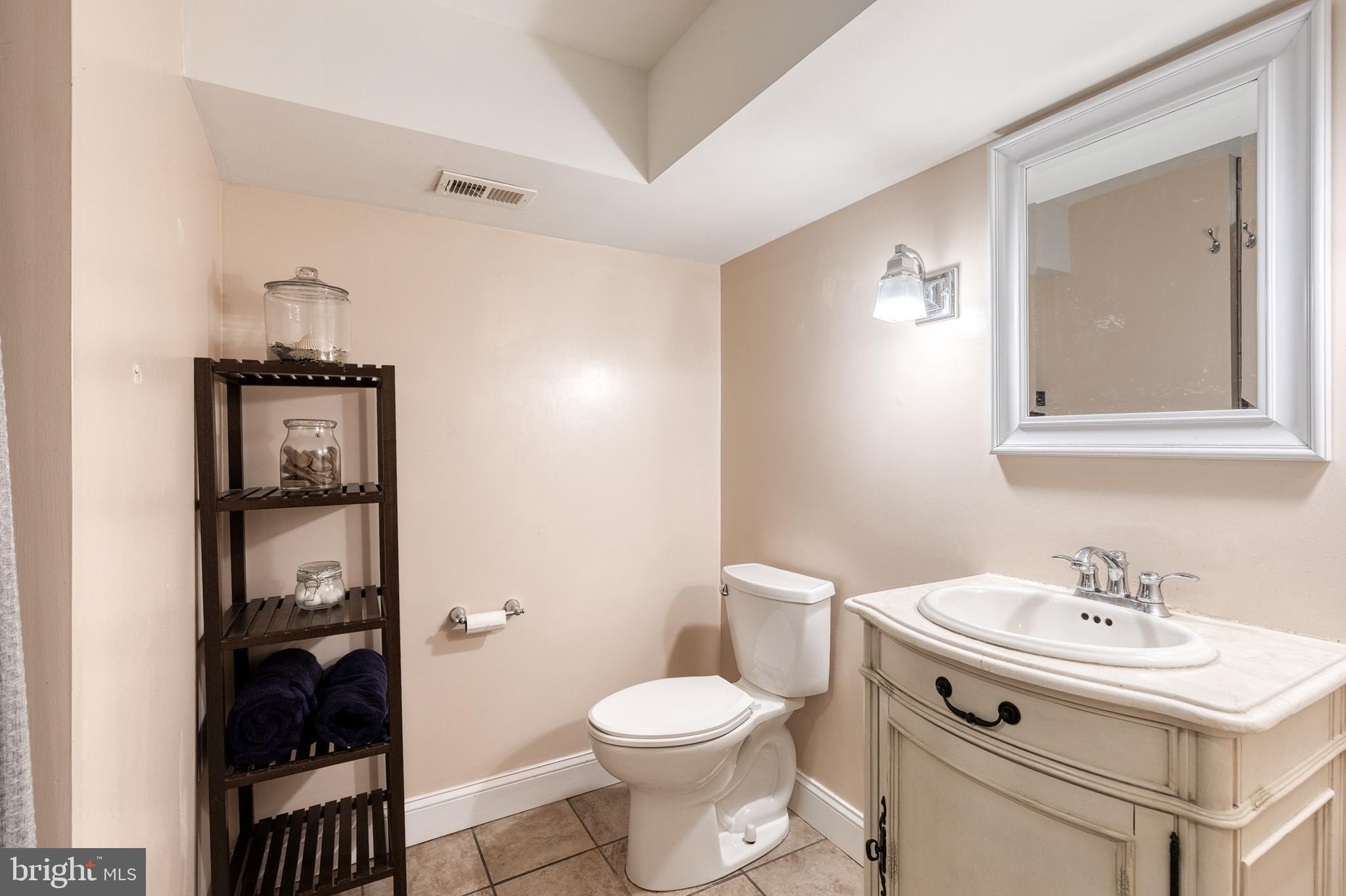 1205 Roland Heights Avenue Baltimore, MD 21211 - Photo 25 of 36 a bathroom with a sink toilet and vanity