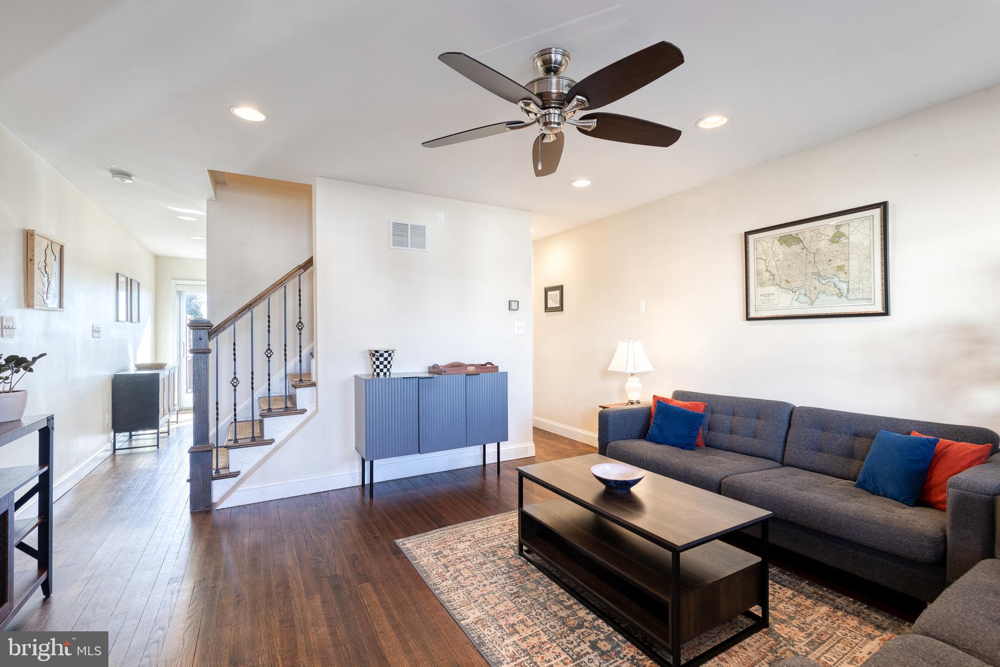 1205 Roland Heights Avenue Baltimore, MD 21211 - Photo 4 of 36 a living room with furniture and a wooden floor