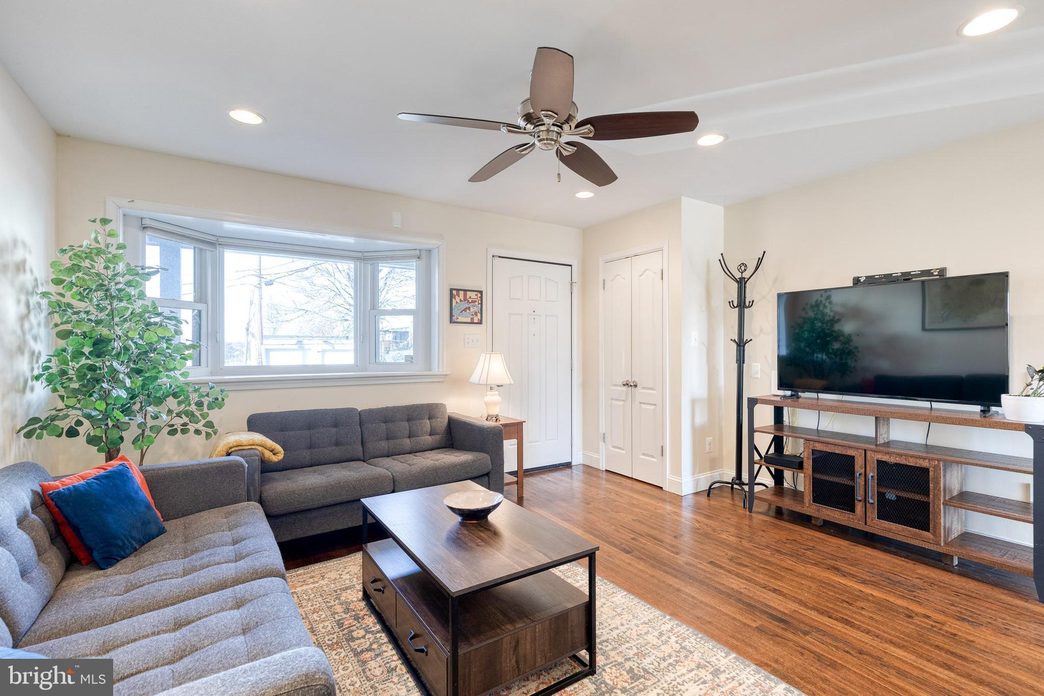 1205 Roland Heights Avenue Baltimore, MD 21211 - Photo 6 of 36 a living room with furniture and a flat screen tv