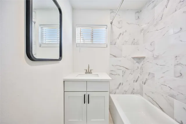 a bathroom with a sink a bathtub and a shower