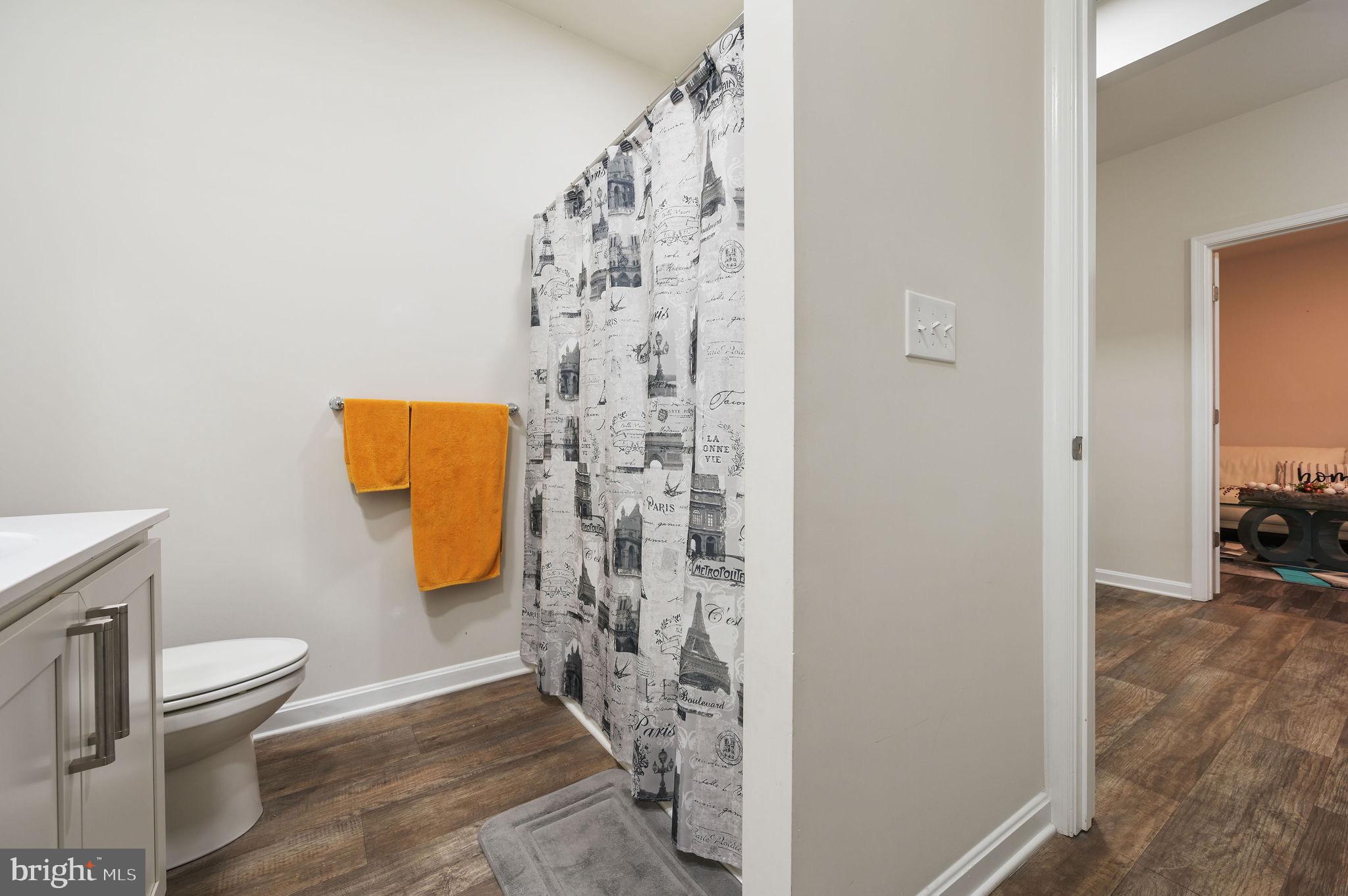 157 Clear Stream Drive Dover, DE 19904 - Photo 11 of 17 a bathroom with a toilet and a shower curtain