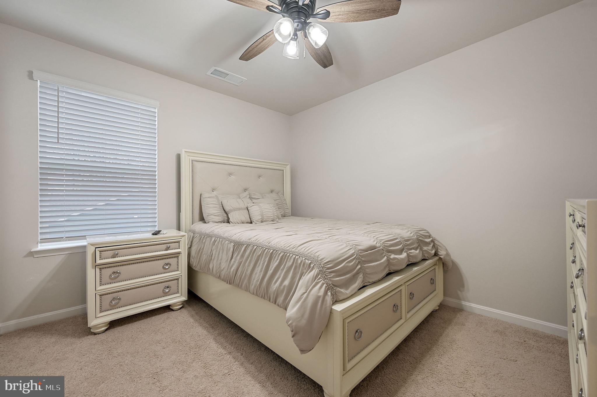 157 Clear Stream Drive Dover, DE 19904 - Photo 14 of 17 a bed room with a bed and a ceiling fan