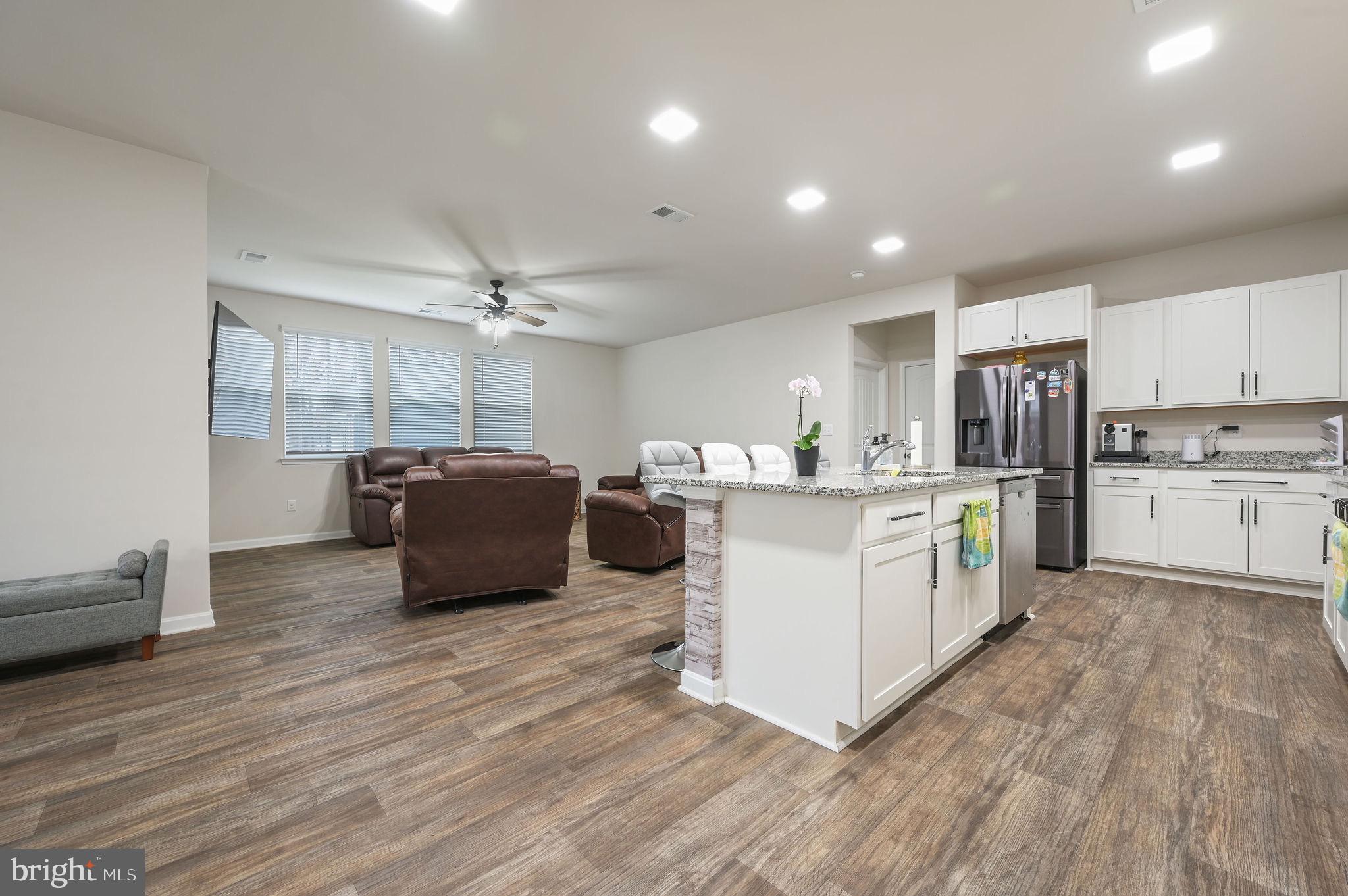 157 Clear Stream Drive Dover, DE 19904 - Photo 2 of 17 a large white kitchen with wooden floor and stainless steel appliances