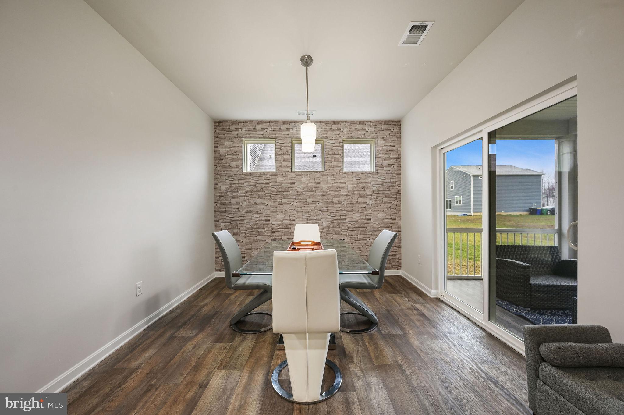 157 Clear Stream Drive Dover, DE 19904 - Photo 5 of 17 a view of a dining room with furniture window and wooden floor