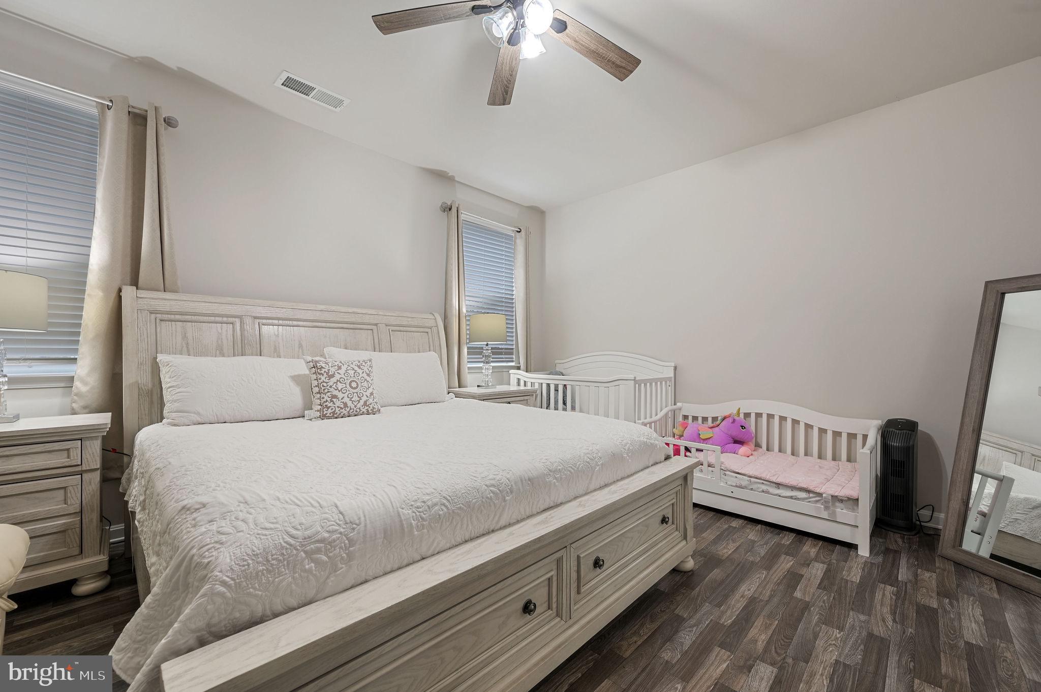 157 Clear Stream Drive Dover, DE 19904 - Photo 7 of 17 a bedroom with a white bed and a chandelier