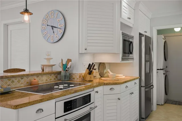 a kitchen with stainless steel appliances granite countertop a stove and a refrigerator
