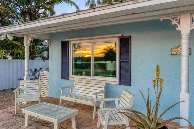 a view of a chairs and table in patio