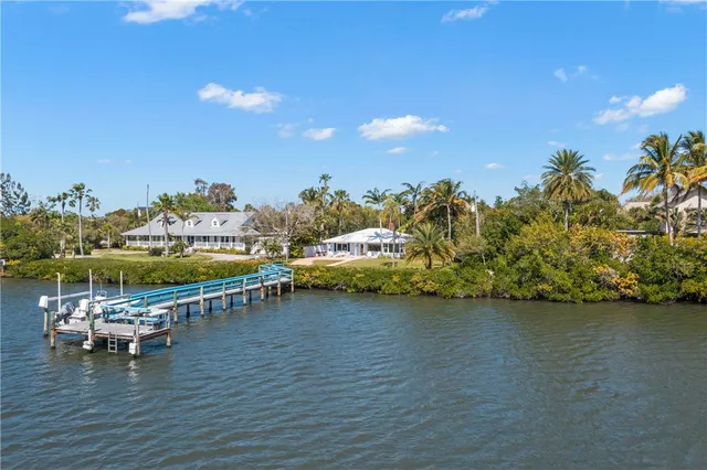 a view of a lake with lawn chairs