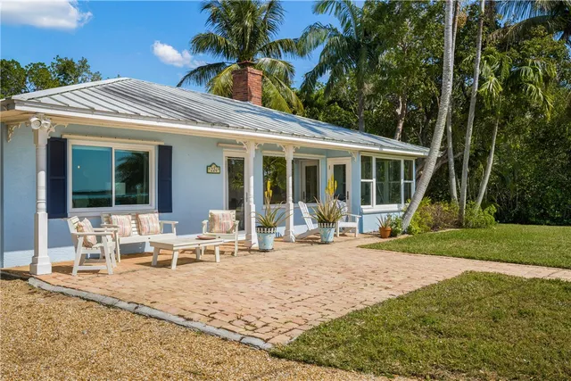 a view of a house with backyard porch and sitting area