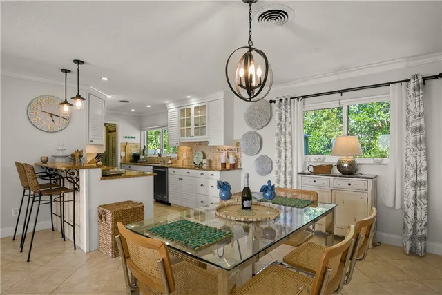 a living room with dining table and a table