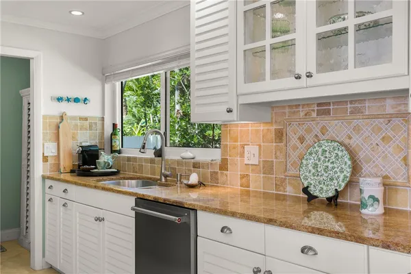 a kitchen with stainless steel appliances granite countertop a sink and a window