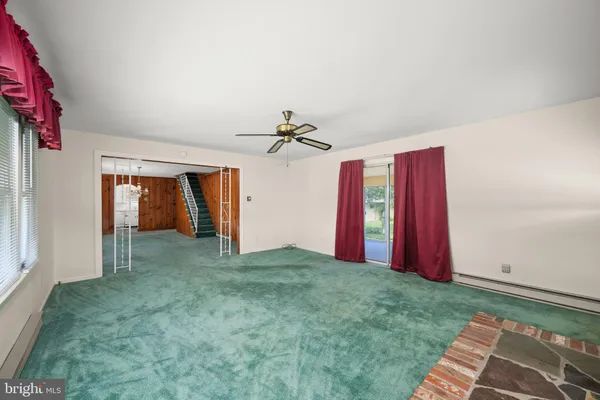a view of a room with window and ceiling fan