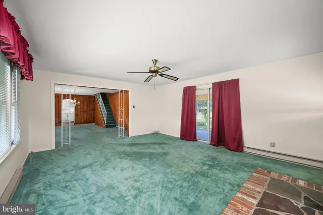 a view of a room with window and ceiling fan