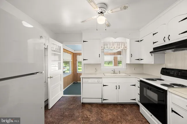 a kitchen with stainless steel appliances cabinets a sink and a stove