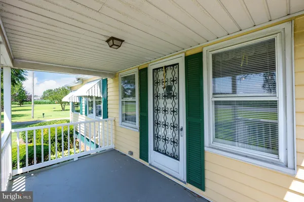 a view of green field with sitting area