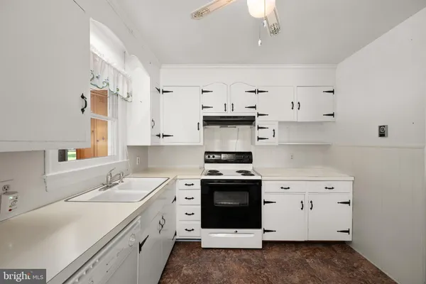 a kitchen with cabinets appliances and a sink