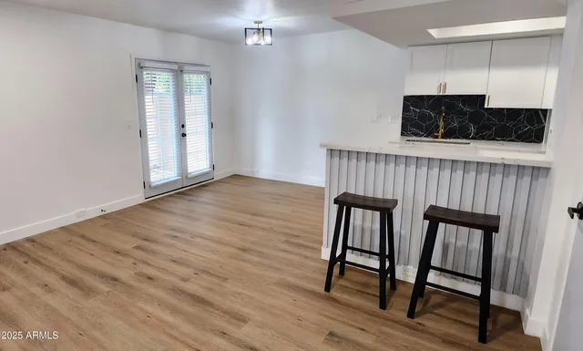 a view of an empty room and wooden floor