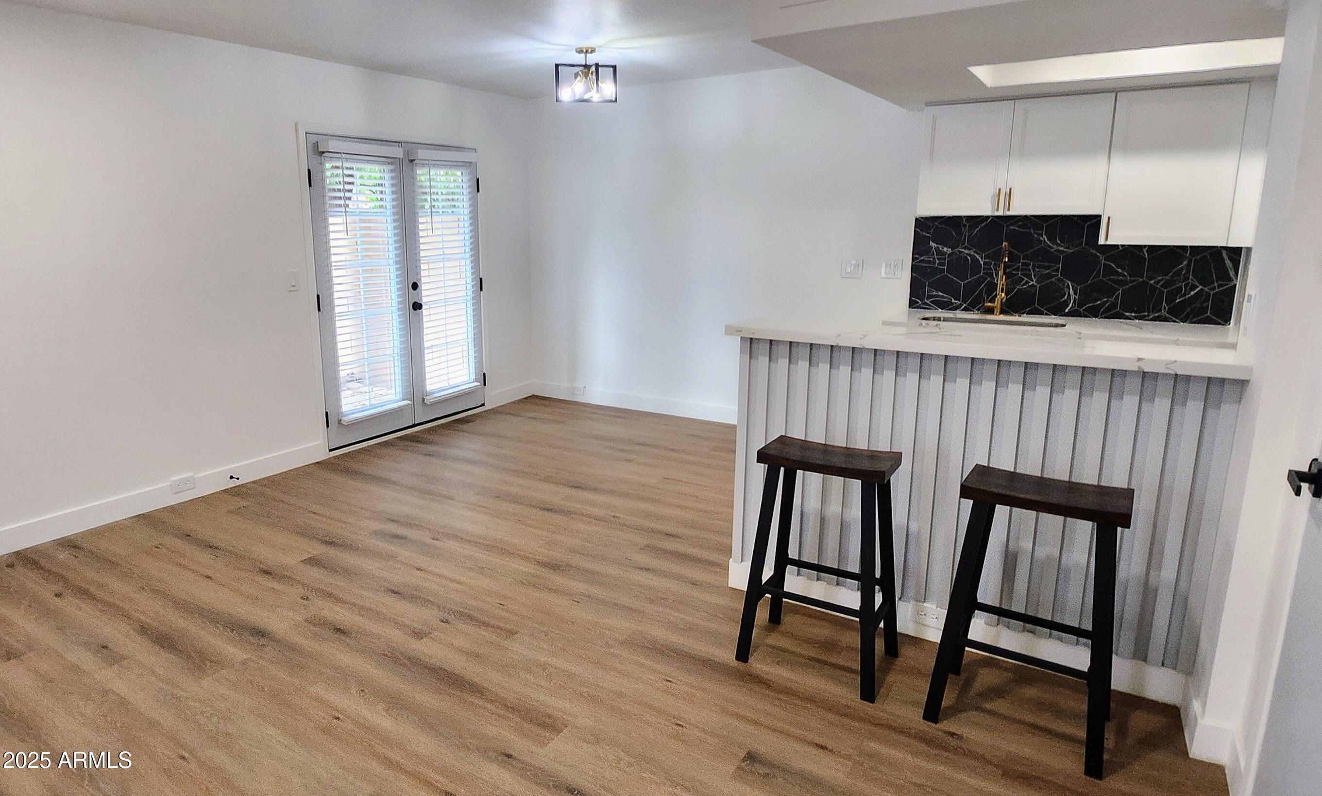 a view of an empty room and wooden floor