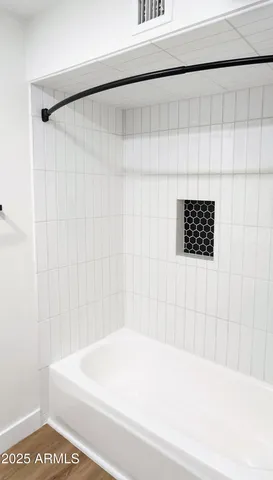 a bathroom with a white bathtub and a shower curtain
