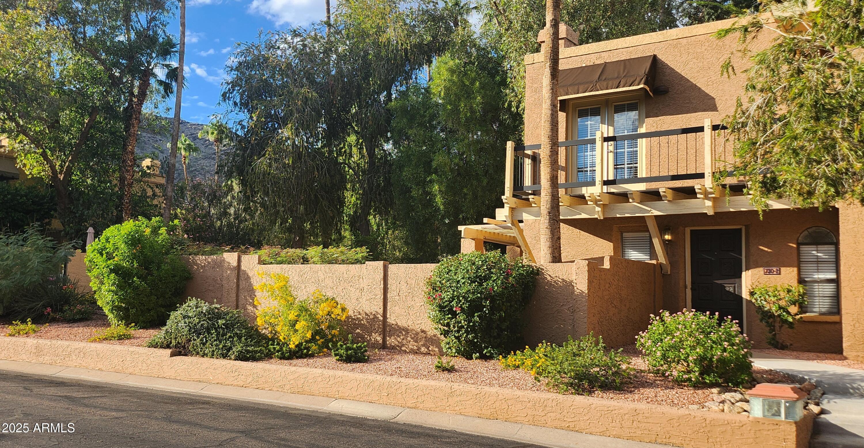 730 East North Lane, Unit 2 Phoenix, AZ 85020 - Photo 14 of 17 a front view of a house with a yard