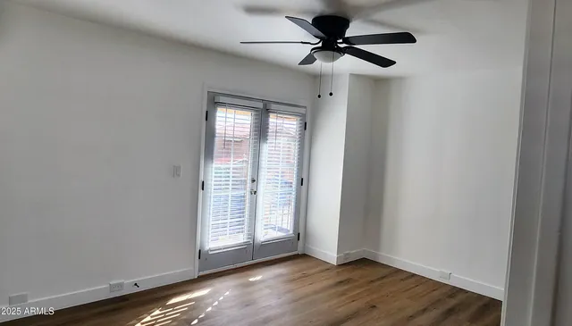 wooden floor in an empty room with a window