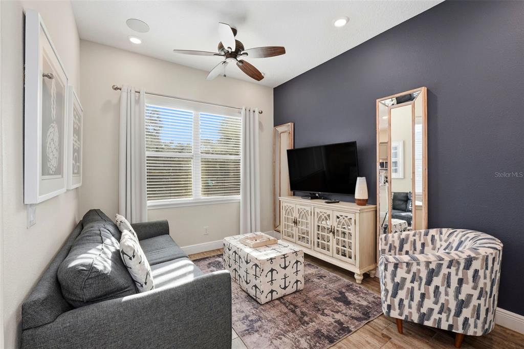 8098 Knee Deep Road Kissimmee, FL 34747 - Photo 13 of 40 a living room with furniture and a flat screen tv