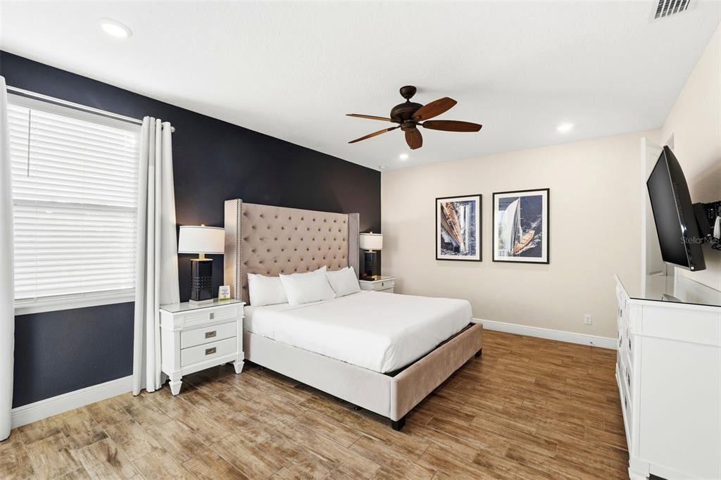 8098 Knee Deep Road Kissimmee, FL 34747 - Photo 15 of 40 a bedroom with a bed and a flat screen tv