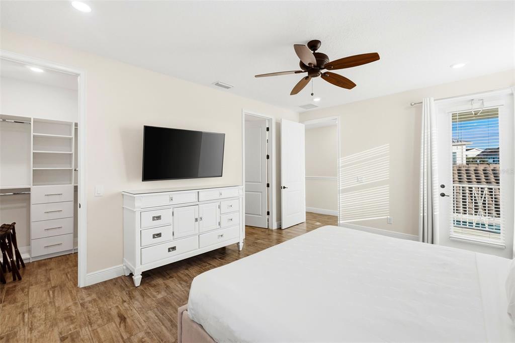 8098 Knee Deep Road Kissimmee, FL 34747 - Photo 16 of 40 a bedroom with a bed and a flat screen tv