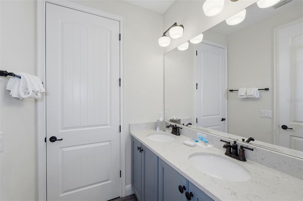 8098 Knee Deep Road Kissimmee, FL 34747 - Photo 17 of 40 a bathroom with a double vanity sink mirror and vanity