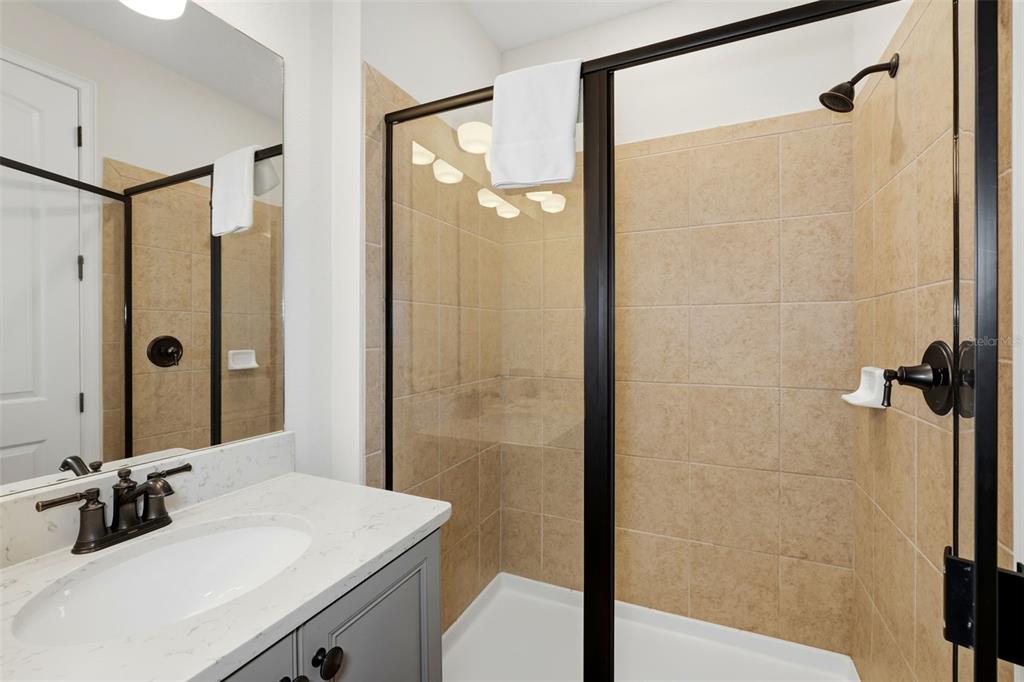 8098 Knee Deep Road Kissimmee, FL 34747 - Photo 18 of 40 a bathroom with a sink and a mirror