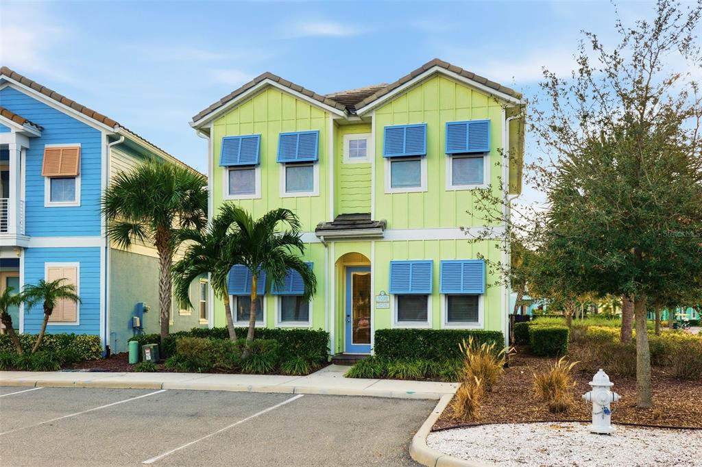 8098 Knee Deep Road Kissimmee, FL 34747 - Photo 2 of 40 a front view of a house with a yard and trees