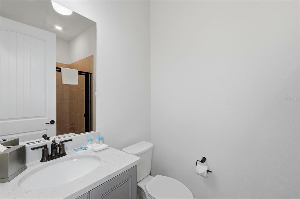 8098 Knee Deep Road Kissimmee, FL 34747 - Photo 22 of 40 a bathroom with a sink vanity mirror and toilet