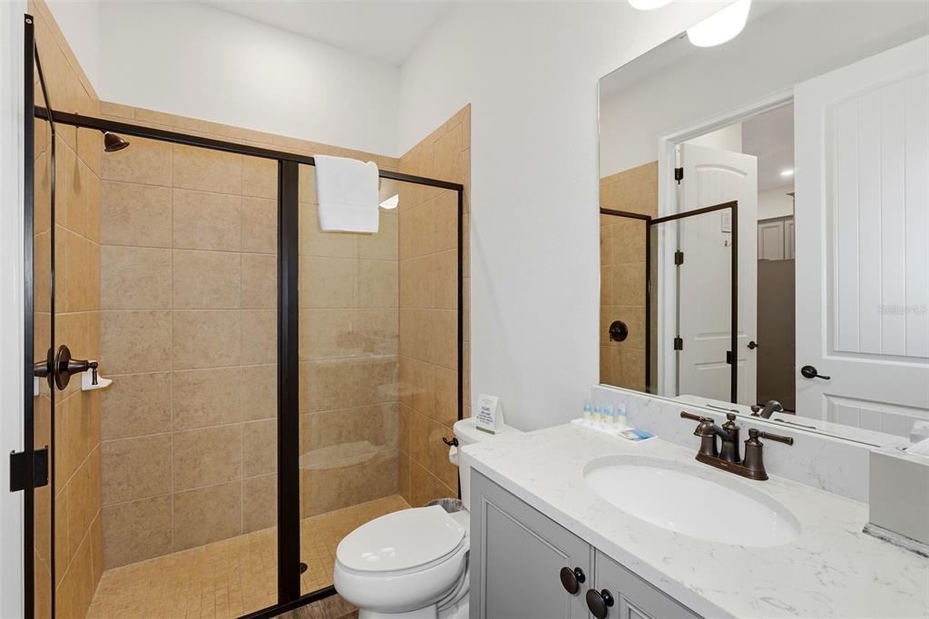 8098 Knee Deep Road Kissimmee, FL 34747 - Photo 25 of 40 a bathroom with a sink a toilet and shower