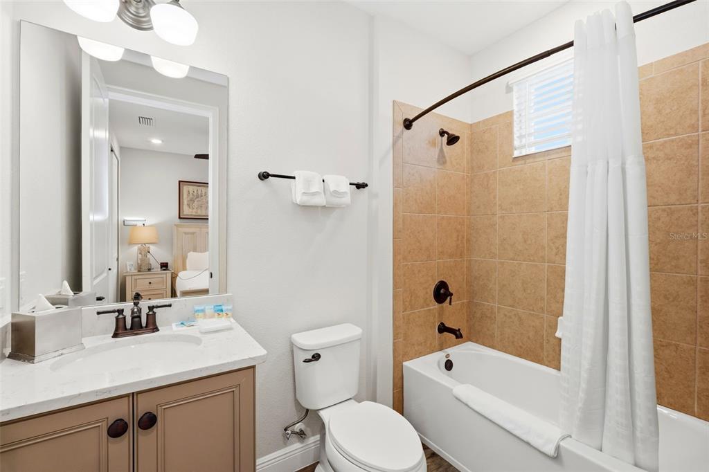 8098 Knee Deep Road Kissimmee, FL 34747 - Photo 28 of 40 a bathroom with a sink a toilet and shower