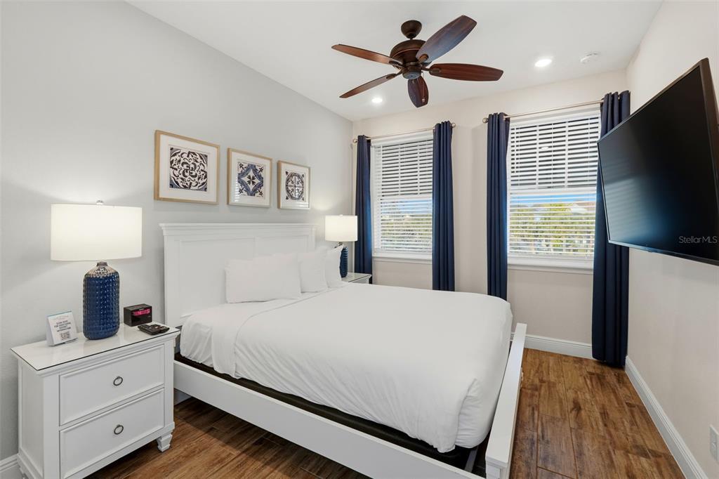 8098 Knee Deep Road Kissimmee, FL 34747 - Photo 29 of 40 a bedroom with a large bed and a flat screen tv