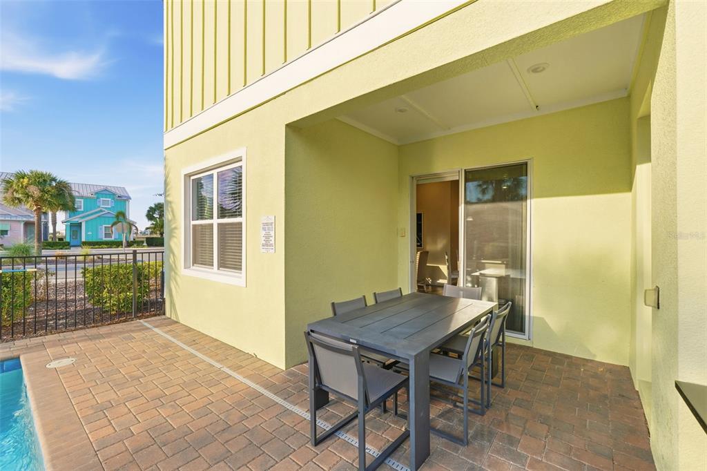 8098 Knee Deep Road Kissimmee, FL 34747 - Photo 32 of 40 a backyard of a house with a table and chairs