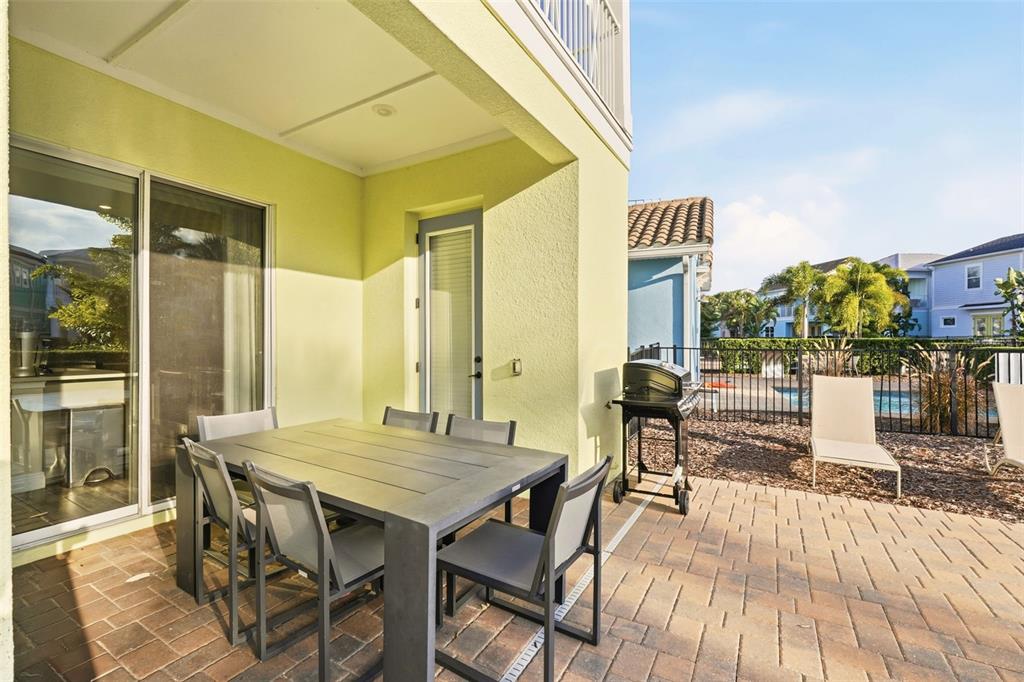 8098 Knee Deep Road Kissimmee, FL 34747 - Photo 33 of 40 a patio with glass top table and chairs