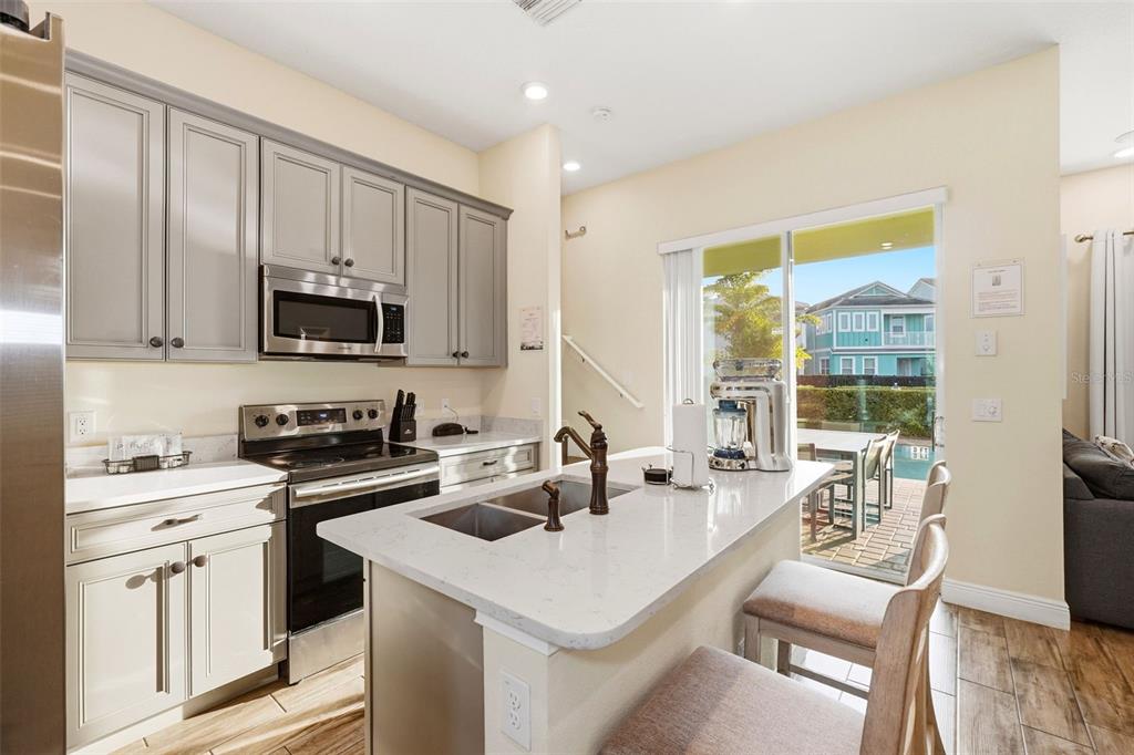 8098 Knee Deep Road Kissimmee, FL 34747 - Photo 6 of 40 a kitchen that has a sink and a stove top oven