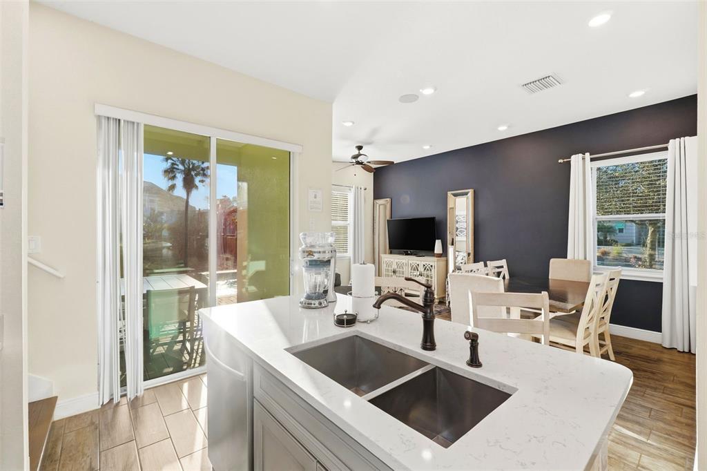 8098 Knee Deep Road Kissimmee, FL 34747 - Photo 7 of 40 a view of kitchen island a sink and living room