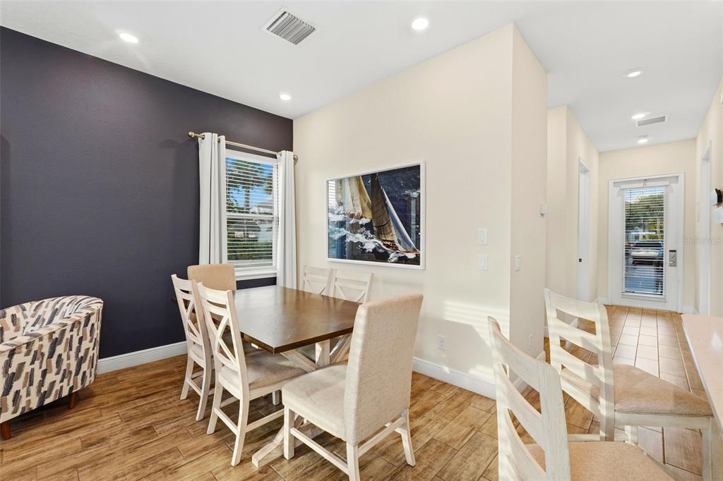 8098 Knee Deep Road Kissimmee, FL 34747 - Photo 10 of 40 a view of a dining room with furniture and wooden floor