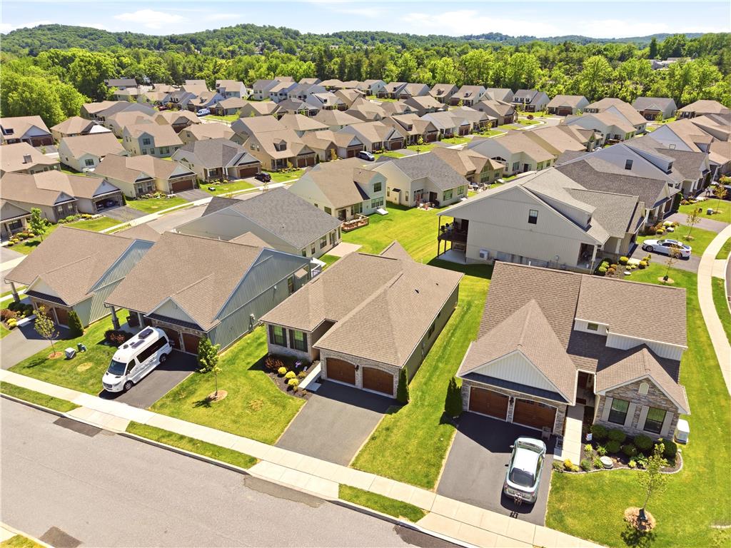 4120 Eveningstar Road Emmaus, PA 18049 - Photo 3 of 62 An aerial perspective reveals a well-maintained neighborhood of contemporary homes nestled against a verdant, rolling landscape.