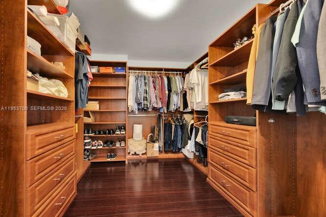 8395 Southwest 73rd Avenue, Unit 104 Miami, FL 33143 - Photo 18 of 35 a view of walk in closet with clothes and shoes